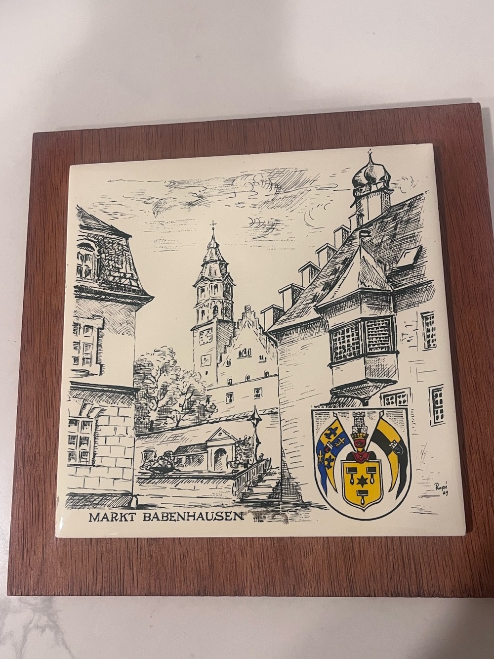 vintage souvenir ceramic tile trivet (hot plate) mounted in a wooden frame.